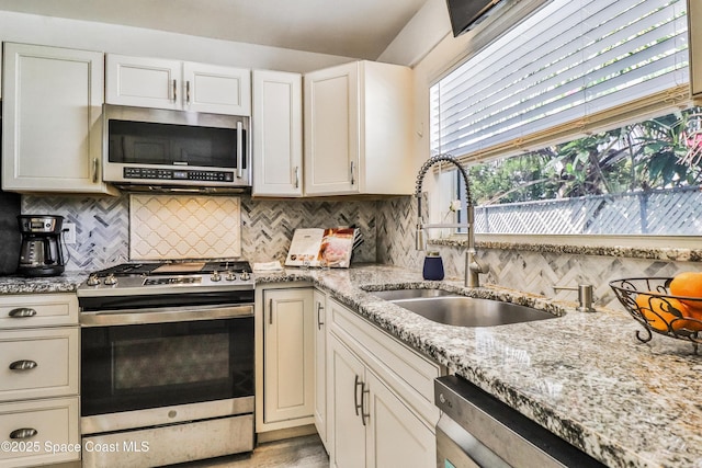 348 Berkeley St, Satellite Beach, FL 32937 - kitchen with stainless steel appliances, decorative backsplash, light stone countertops, light wood-type flooring, and white cabinets