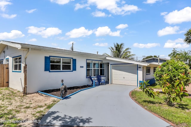 348 Berkeley St, Satellite Beach, FL 32937 - ranch-style home with an attached garage, stucco siding, and concrete driveway