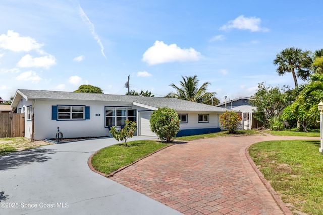 348 Berkeley St, Satellite Beach, FL 32937 - ranch-style home with curved driveway, a garage, and stucco siding