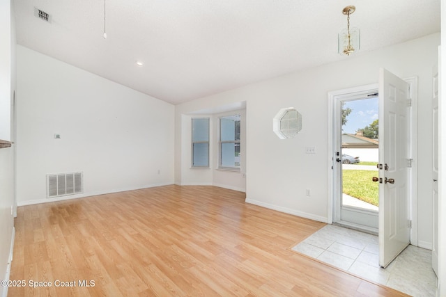 6856 Buxton Ave, Cocoa, FL 32927 - foyer featuring light wood-style flooring and vaulted ceiling