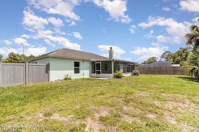 6856 Buxton Ave, Cocoa, FL 32927 - back of property featuring a sunroom, a fenced backyard, a chimney, and stucco siding