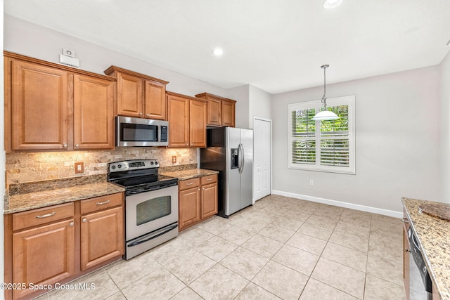 3654 Gurrero Dr, Melbourne, FL 32940 - kitchen with appliances with stainless steel finishes, decorative backsplash, brown cabinets, light stone countertops, and hanging light fixtures