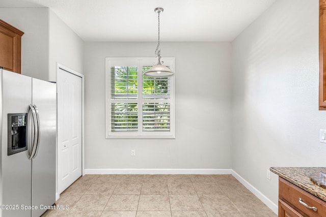 3654 Gurrero Dr, Melbourne, FL 32940 - unfurnished dining area with baseboards and light tile patterned floors