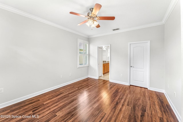 3654 Gurrero Dr, Melbourne, FL 32940 - unfurnished bedroom featuring dark wood finished floors, crown molding, connected bathroom, and a ceiling fan
