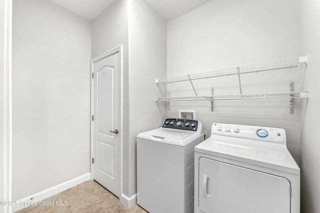 3654 Gurrero Dr, Melbourne, FL 32940 - washroom featuring washing machine and clothes dryer and light tile patterned flooring