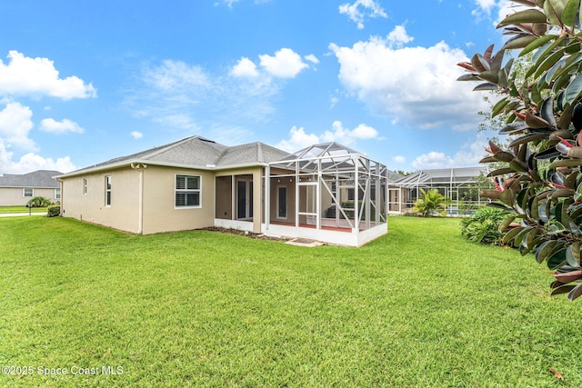 3654 Gurrero Dr, Melbourne, FL 32940 - rear view of house featuring a lawn, stucco siding, and a lanai