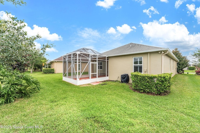 3654 Gurrero Dr, Melbourne, FL 32940 - back of property with stucco siding, a yard, and a lanai