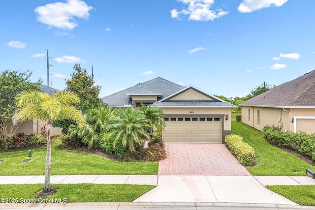 3654 Gurrero Dr, Melbourne, FL 32940 - ranch-style home featuring stucco siding, a front yard, decorative driveway, a garage, and roof with shingles
