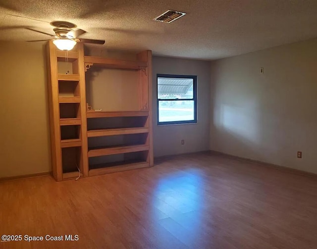 463 Spring Ln, Ocala, FL 34472 - unfurnished bedroom featuring wood finished floors, a textured ceiling, baseboards, and ceiling fan