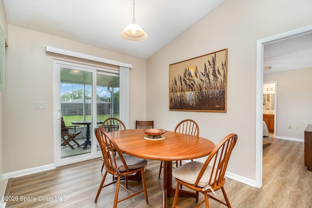 1265 Helias St NW, Palm Bay, FL 32907 - dining area with light wood-style floors, lofted ceiling, and baseboards