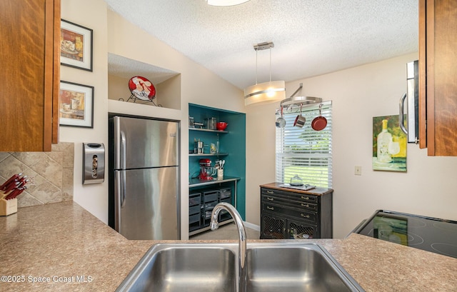 1265 Helias St NW, Palm Bay, FL 32907 - kitchen with freestanding refrigerator, a sink, decorative backsplash, a textured ceiling, and electric range