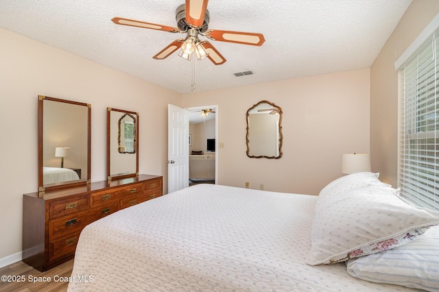1265 Helias St NW, Palm Bay, FL 32907 - bedroom with light wood-style flooring, ceiling fan, and a textured ceiling