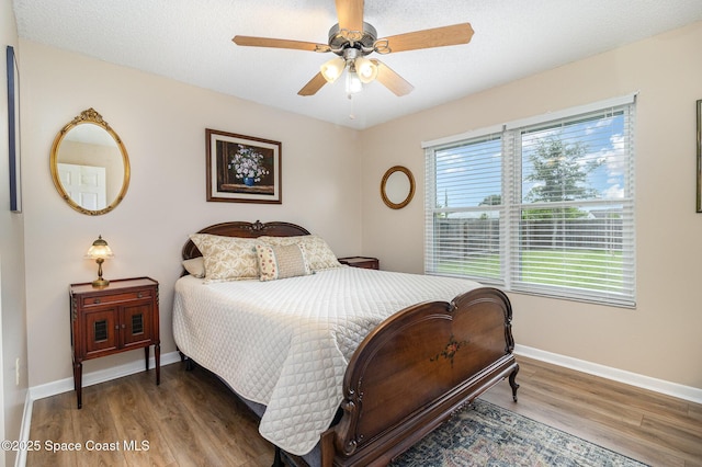 1265 Helias St NW, Palm Bay, FL 32907 - bedroom with wood finished floors, baseboards, and ceiling fan