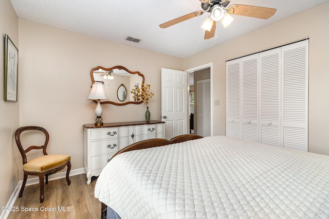 1265 Helias St NW, Palm Bay, FL 32907 - bedroom with wood finished floors, a closet, baseboards, and ceiling fan
