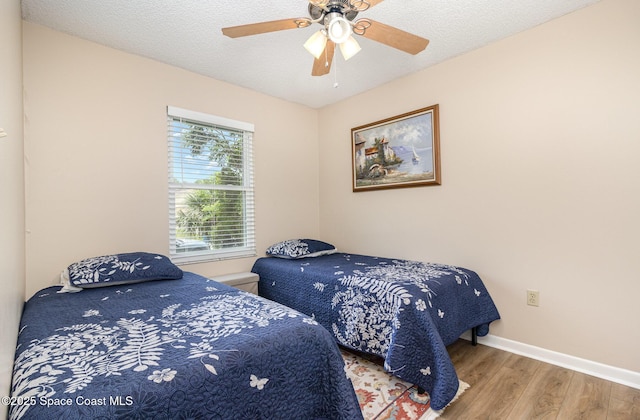 1265 Helias St NW, Palm Bay, FL 32907 - bedroom with wood finished floors, baseboards, and a ceiling fan