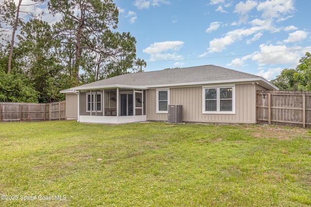 1265 Helias St NW, Palm Bay, FL 32907 - back of house with central AC, a sunroom, roof with shingles, and board and batten siding