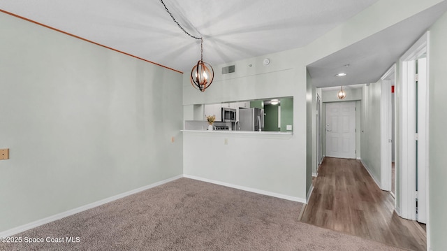 1420 Huntington Ln Unit 2405, Rockledge, FL 32955 - unfurnished dining area with a chandelier and carpet floors