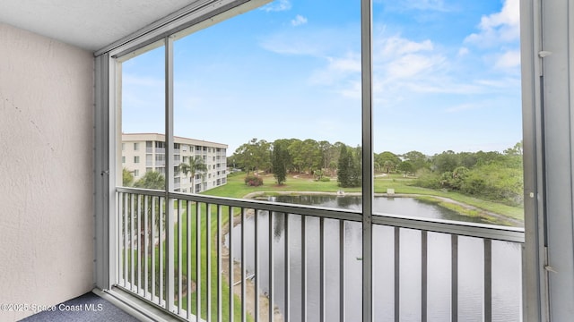 1420 Huntington Ln Unit 2405, Rockledge, FL 32955 - unfurnished sunroom featuring a water view and view of scattered trees