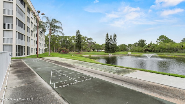 1420 Huntington Ln Unit 2405, Rockledge, FL 32955 - view of community featuring a water view, shuffleboard, a yard, and view of wooded area