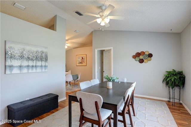 241 High Rd NW, Palm Bay, FL 32907 - dining room featuring a ceiling fan, light wood-style flooring, lofted ceiling, baseboards, and a textured ceiling
