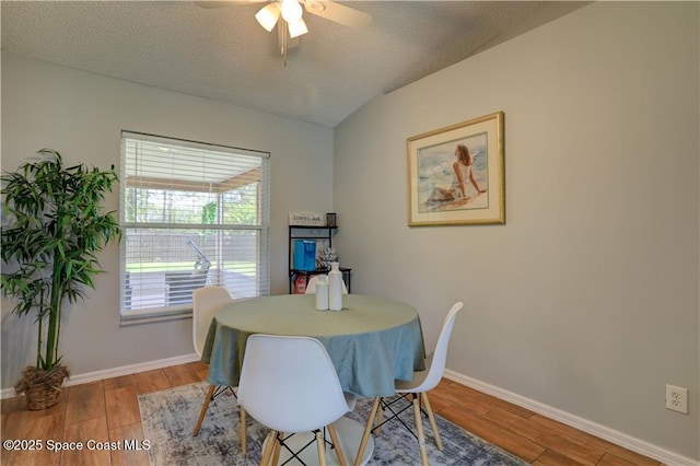 241 High Rd NW, Palm Bay, FL 32907 - dining area featuring light wood-style flooring, ceiling fan, baseboards, and a textured ceiling