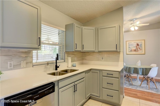 241 High Rd NW, Palm Bay, FL 32907 - kitchen with dishwasher, a sink, decorative backsplash, light tile patterned flooring, and light countertops