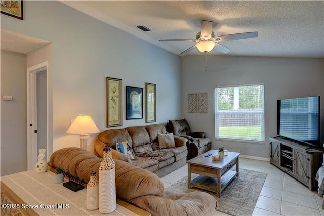 241 High Rd NW, Palm Bay, FL 32907 - living room with vaulted ceiling, ceiling fan, a textured ceiling, and light tile patterned flooring