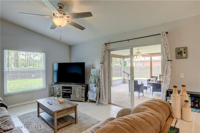 241 High Rd NW, Palm Bay, FL 32907 - living room featuring ceiling fan, a textured ceiling, lofted ceiling, light tile patterned flooring, and baseboards