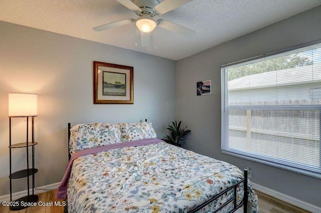 241 High Rd NW, Palm Bay, FL 32907 - bedroom featuring wood finished floors, baseboards, a textured ceiling, and ceiling fan