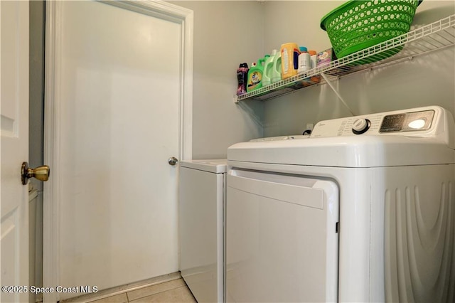241 High Rd NW, Palm Bay, FL 32907 - washroom featuring independent washer and dryer and light tile patterned floors