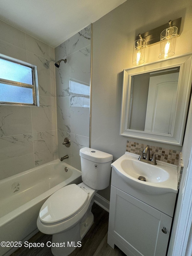 711 Sara Jane Ln, Merritt Island, FL 32952 - full bathroom featuring vanity, shower / bath combination, toilet, and wood finished floors