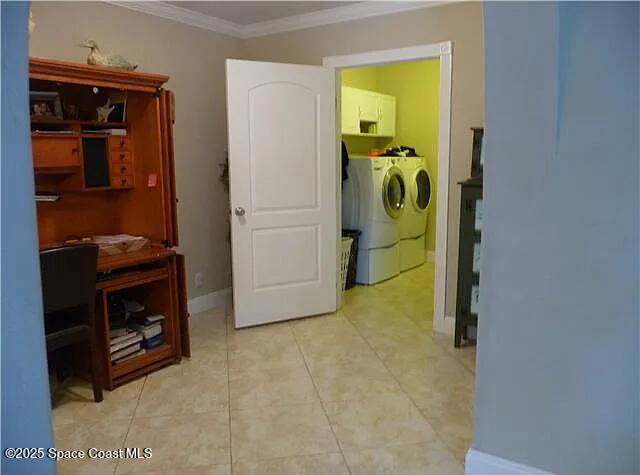 22100 Serenata Cir W, Boca Raton, FL 33428 - hallway with ornamental molding, washer and dryer, tile patterned flooring, and baseboards