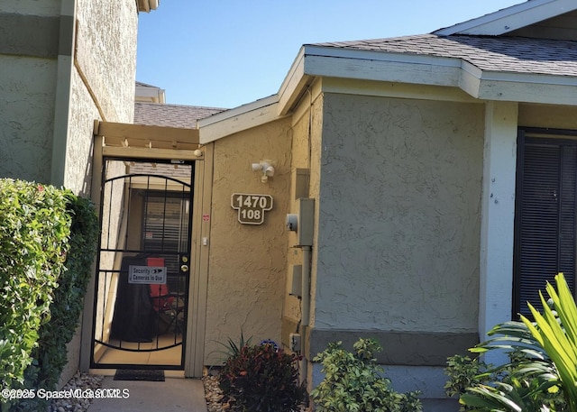 1470 Sheafe Ave NE Unit 108, Palm Bay, FL 32905 - property entrance with roof with shingles and stucco siding