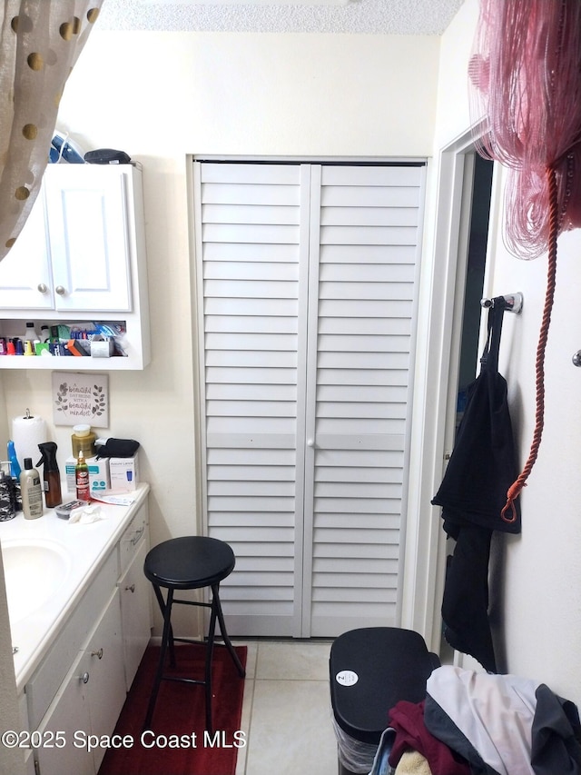 1470 Sheafe Ave NE Unit 108, Palm Bay, FL 32905 - bathroom with a closet, vanity, and tile patterned floors
