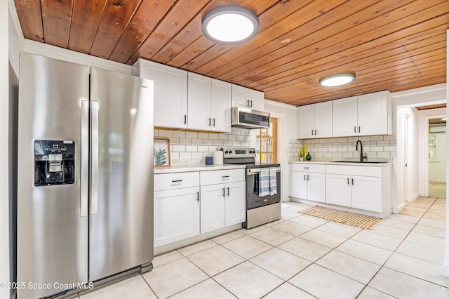 321 Sagamore St, Melbourne, FL 32904 - kitchen featuring stainless steel appliances, wood ceiling, light tile patterned flooring, tasteful backsplash, and light countertops