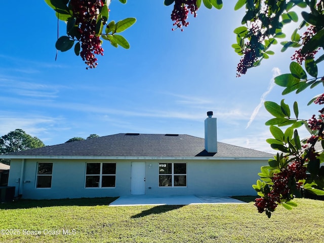 1271 Rabbit St SE, Palm Bay, FL 32909 - back of house featuring a patio, a lawn, a chimney, roof with shingles, and stucco siding