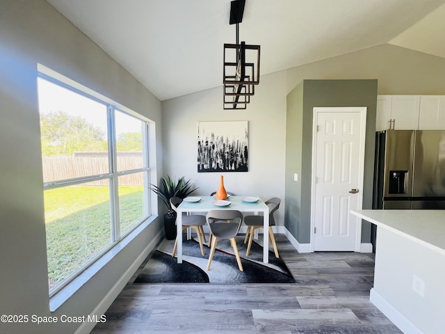 1271 Rabbit St SE, Palm Bay, FL 32909 - dining area featuring lofted ceiling, baseboards, and wood finished floors