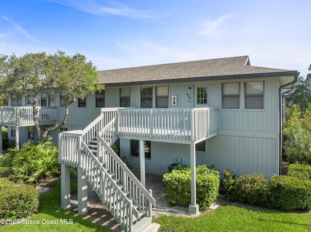 654 Centre Ct SW Unit 201, Vero Beach, FL 32962 - view of front of property featuring roof with shingles and stairs