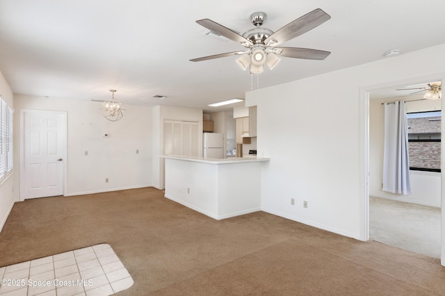 654 Centre Ct SW Unit 201, Vero Beach, FL 32962 - unfurnished living room with light carpet, ceiling fan, a chandelier, and baseboards