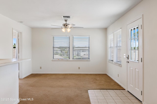 654 Centre Ct SW Unit 201, Vero Beach, FL 32962 - entrance foyer featuring light colored carpet, ceiling fan, and baseboards