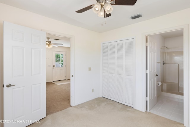 654 Centre Ct SW Unit 201, Vero Beach, FL 32962 - unfurnished bedroom with light colored carpet, a closet, a ceiling fan, baseboards, and ensuite bathroom