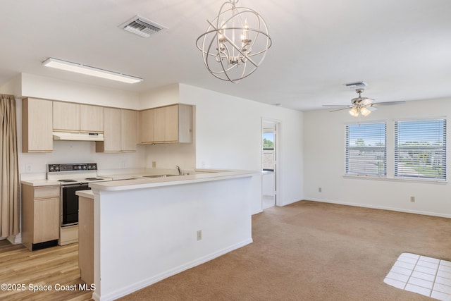 654 Centre Ct SW Unit 201, Vero Beach, FL 32962 - kitchen featuring electric range oven, under cabinet range hood, light brown cabinetry, light countertops, and a peninsula