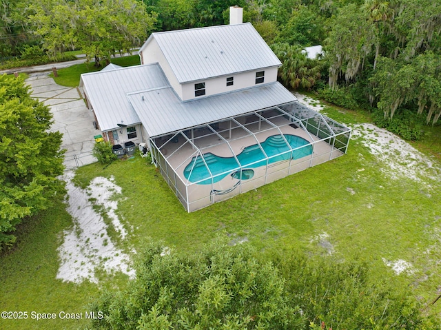 2575 Cox Rd, Cocoa, FL 32926 - view of swimming pool featuring a lanai, a lawn, a patio area, and a pool with connected hot tub