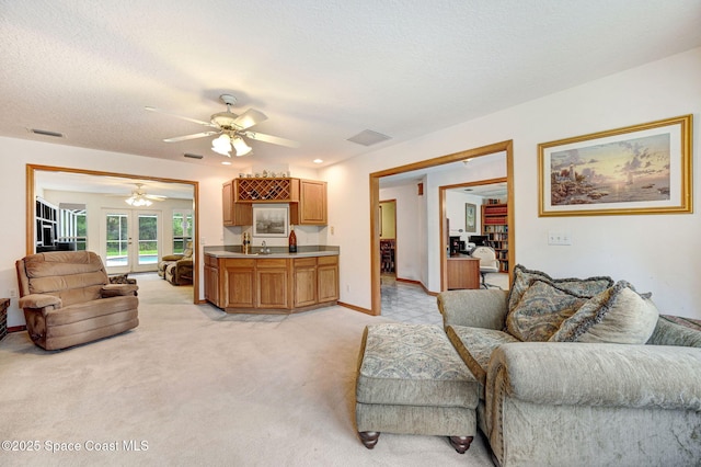 2575 Cox Rd, Cocoa, FL 32926 - living area featuring ceiling fan, french doors, light carpet, and a textured ceiling