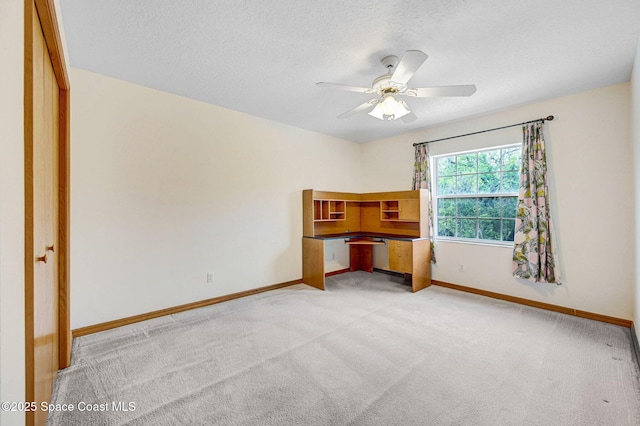 2575 Cox Rd, Cocoa, FL 32926 - unfurnished bedroom with light carpet, a textured ceiling, and a ceiling fan