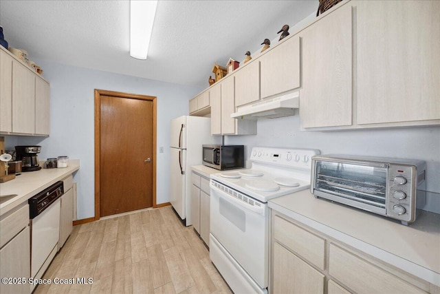 5997 Jenkins Ave, Cocoa, FL 32927 - kitchen featuring under cabinet range hood, white appliances, light countertops, and light wood-style floors