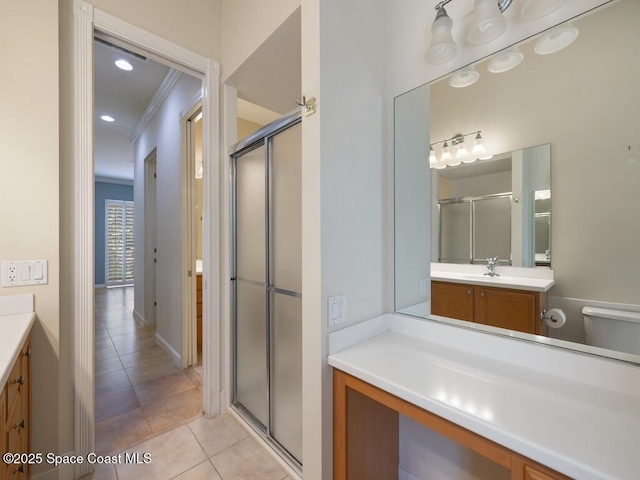 5422 Barbados Sq, Vero Beach, FL 32967 - bathroom featuring vanity, tile patterned flooring, a shower stall, crown molding, and toilet
