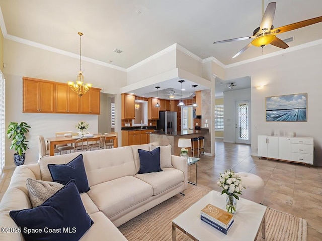5422 Barbados Sq, Vero Beach, FL 32967 - living area featuring a chandelier, baseboards, ornamental molding, a ceiling fan, and light tile patterned flooring