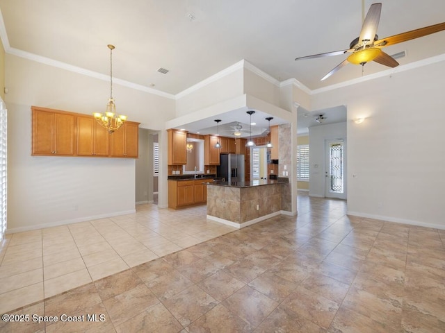 5422 Barbados Sq, Vero Beach, FL 32967 - unfurnished living room with a ceiling fan, baseboards, a chandelier, ornamental molding, and a sink