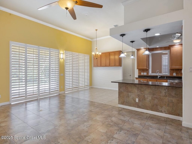 5422 Barbados Sq, Vero Beach, FL 32967 - kitchen featuring a ceiling fan, dark countertops, a sink, baseboards, and ornamental molding